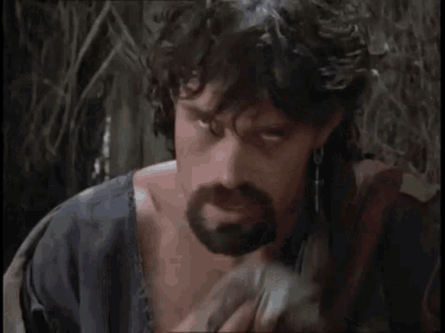 a man with a beard is holding a cloth in his hand