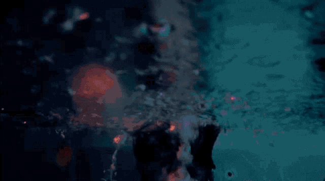 a girl with her arms outstretched is standing in a pool of water