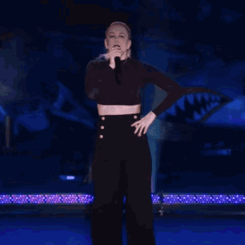 a woman singing into a microphone with the words side note written on the bottom