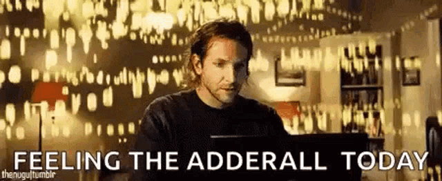 a man is sitting in front of a computer with the words feeling the adderall today