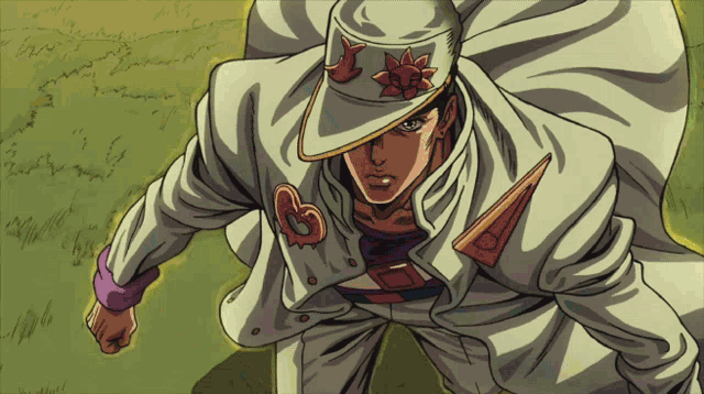 a man wearing a white hat with a red flower and the letter b on it