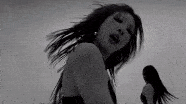 a black and white photo of a woman with long hair dancing