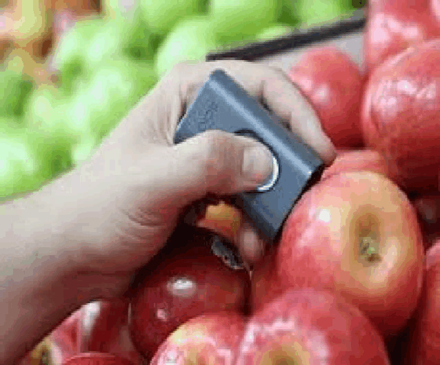 a person is cutting an apple with a knife .
