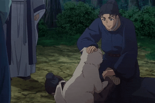 a man in a blue shirt is petting a small white dog