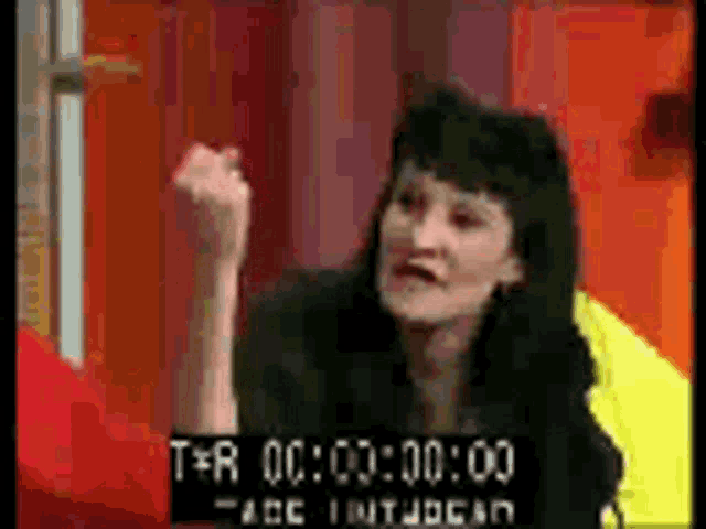 a woman is giving a fist bump in a video that is being edited