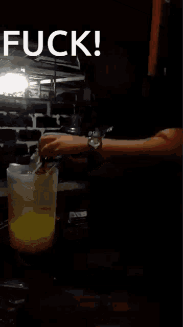 a man sitting at a table with a candle in his hand and the words " fuck " written above him