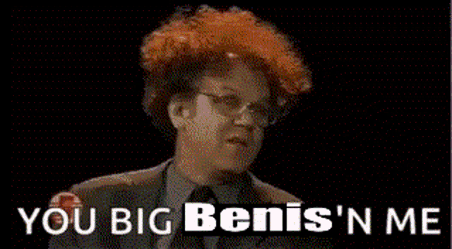 a man with red hair is looking at the camera with the words `` you big benis 'n me '' behind him .