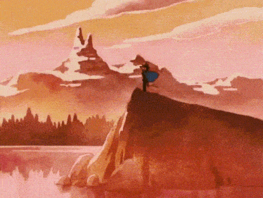 a man in a blue cape stands on top of a mountain