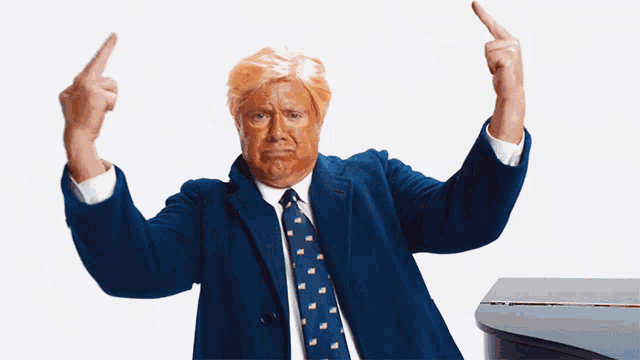 a man in a suit and tie is making a middle finger sign
