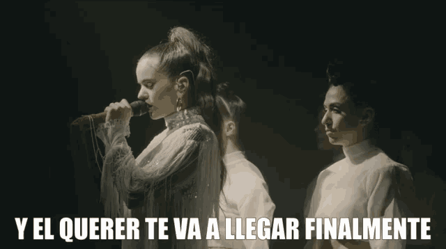 a woman singing into a microphone with the words ya sea buena written below her
