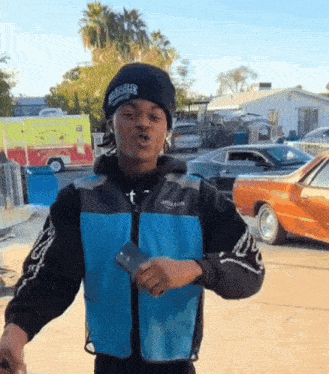 a man wearing a black beanie and a blue jacket that says amazon