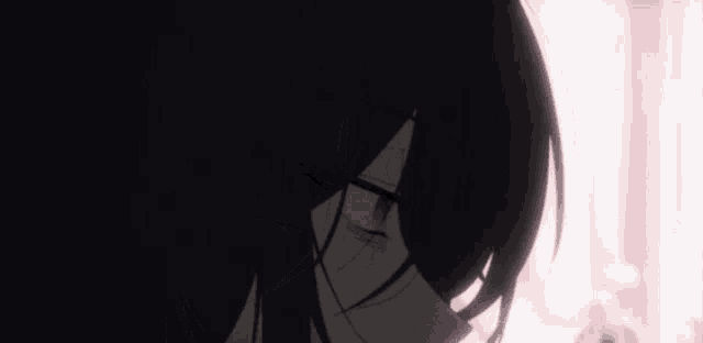 a close up of a person 's face with black hair