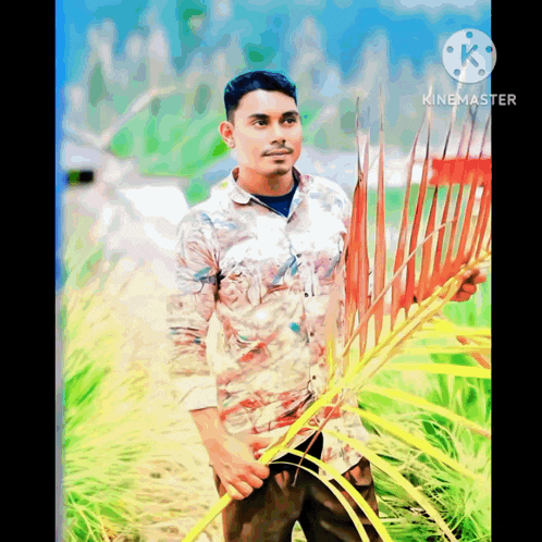 a man is standing in a field holding a red rake