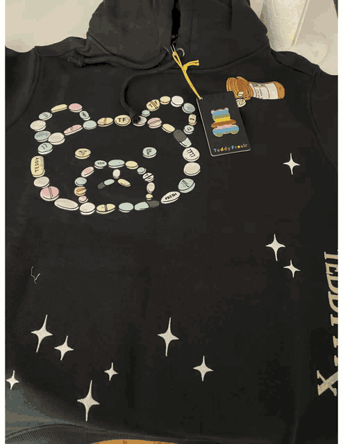 a black hoodie with a label that says teddy bear