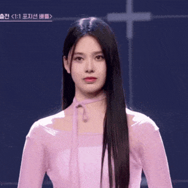 a woman with long black hair is wearing a pink dress
