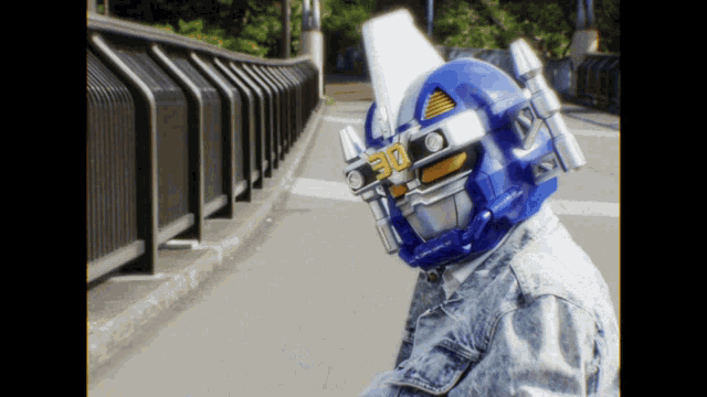 a person wearing a blue robot helmet with the number 30 on it