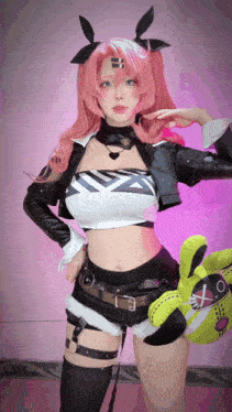 a woman with pink hair and bunny ears holds a stuffed animal in her hand