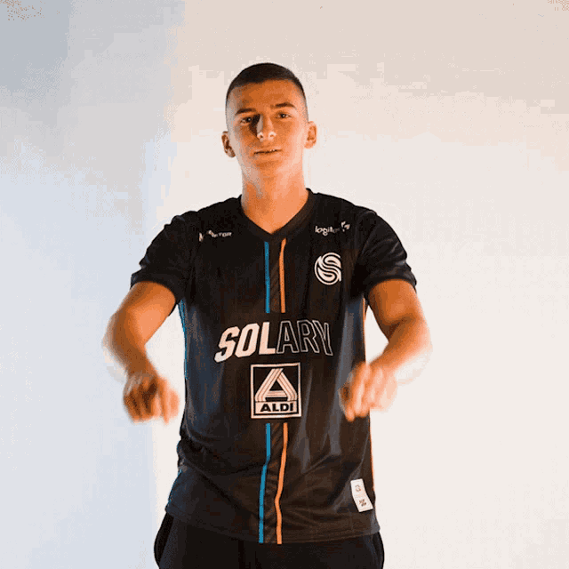 a man wearing a black shirt with solary on it