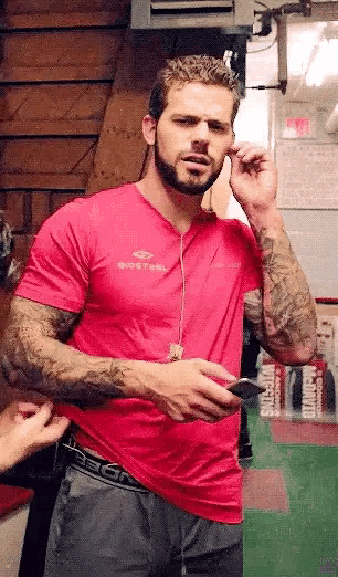 a man with a beard is wearing a pink shirt that says bigsteel