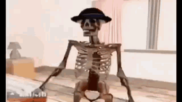 a skeleton wearing a hat is standing on a wooden floor in a bedroom .
