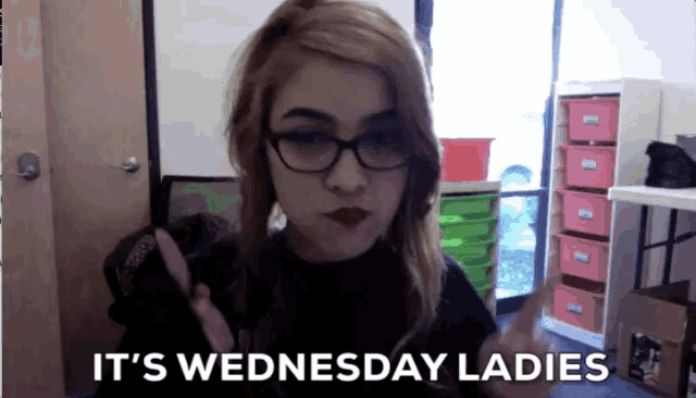 a woman wearing glasses says it 's wednesday ladies in a room