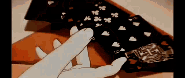 a cartoon of a person playing a game of cards with their fingers .