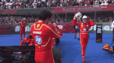 a race winner is being congratulated by his teammate