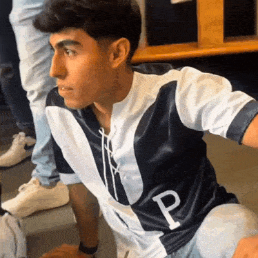 a man wearing a jersey with the letter p on the front