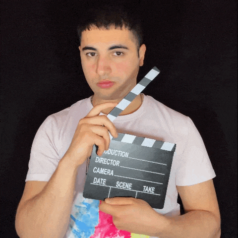 a man holding a clapper board that says production director camera date scene and take