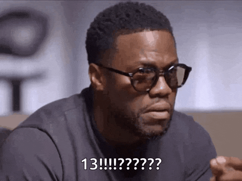a man wearing glasses and a black shirt is sitting on a couch and asking a question .