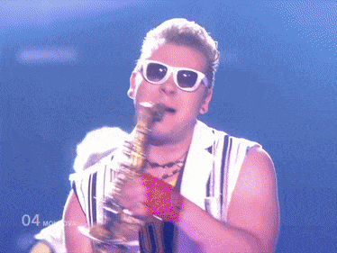 a man playing a saxophone in front of a blue background with the number 04
