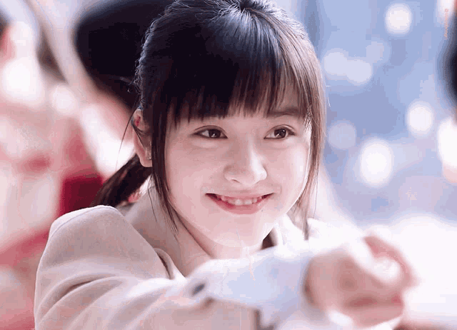 a close up of a girl 's face with a blurred background