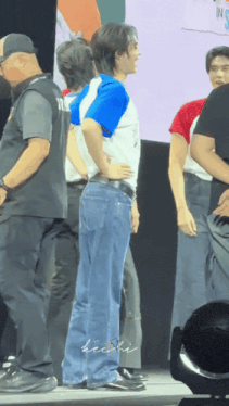 a man standing in front of a sign that says ' ins '