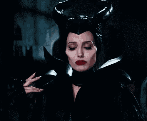 a woman in a costume with horns and the words me encantas on the bottom