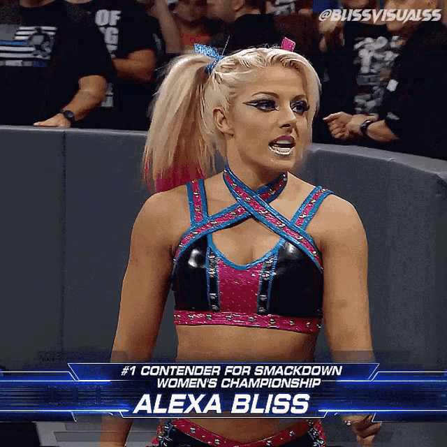 a female wrestler named alexa bliss stands in front of a crowd