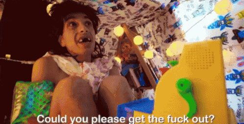 a girl is sitting under a butterfly blanket and asking could you please get the fuck out ?