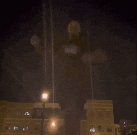 a blurry picture of a city at night with a street light