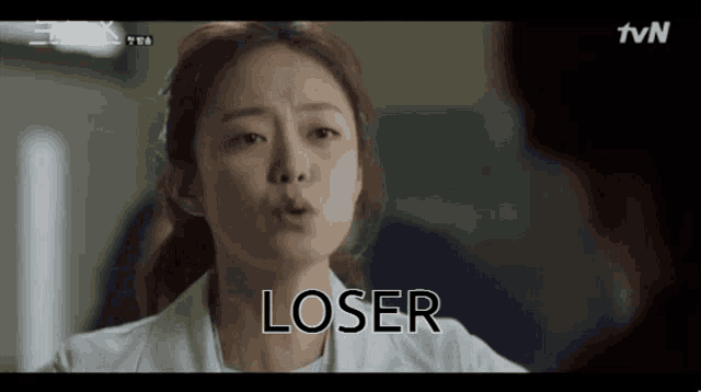 a woman in a white coat says loser in front of another woman