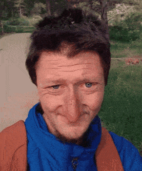 a man wearing a blue jacket has a large nose
