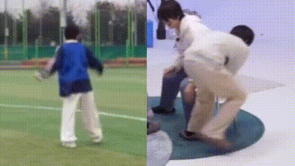 a man in a blue jacket is standing on a soccer field next to a man in a white shirt and pants .