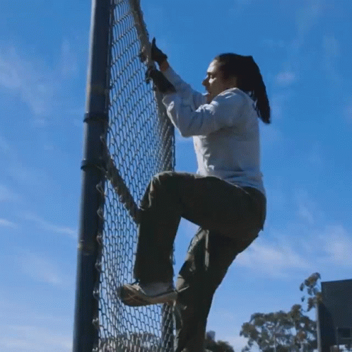 Climbing Up The Fence Michelle Khare GIF - Climbing Up The Fence Michelle Khare Going Up GIFs