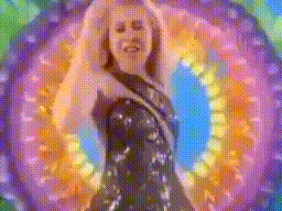 a woman is standing in front of a rainbow colored background .