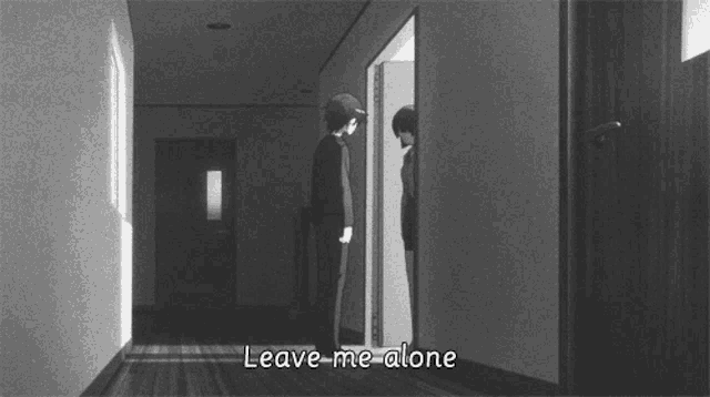 a black and white photo of a man standing in a hallway with the words leave me alone below him