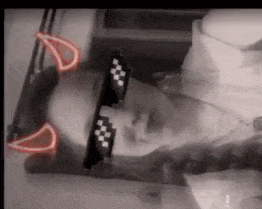 a man wearing sunglasses with devil horns on his head is laying down .
