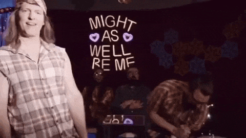 a man is standing in front of a sign that says `` might as well be me '' .