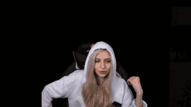 a man is putting a hoodie on a woman who is wearing a hoodie that says thunder.com