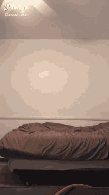a tiktok video of a bed with a blanket on it