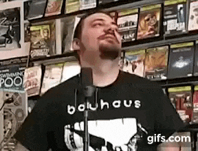 a man is standing in front of a microphone in a store .