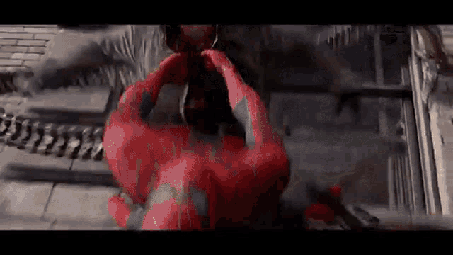 a close up of a person in a spiderman costume holding a spider web .