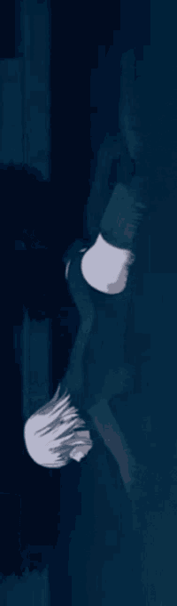 a person is standing upside down in a dark room .